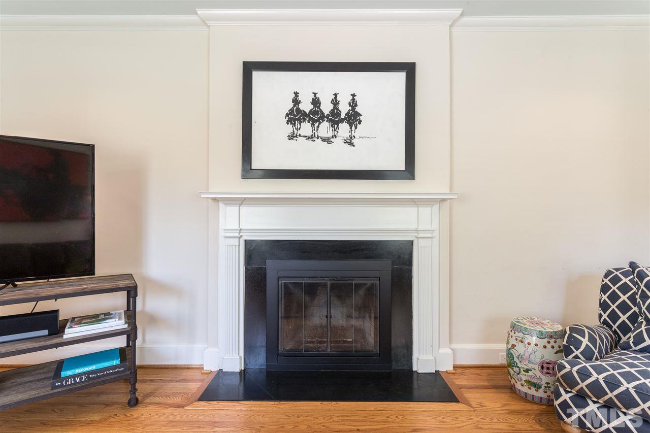 1424 Canterbury Road Raleigh, NC 27608 - Photo 4 of 29 a living room with furniture and a fireplace