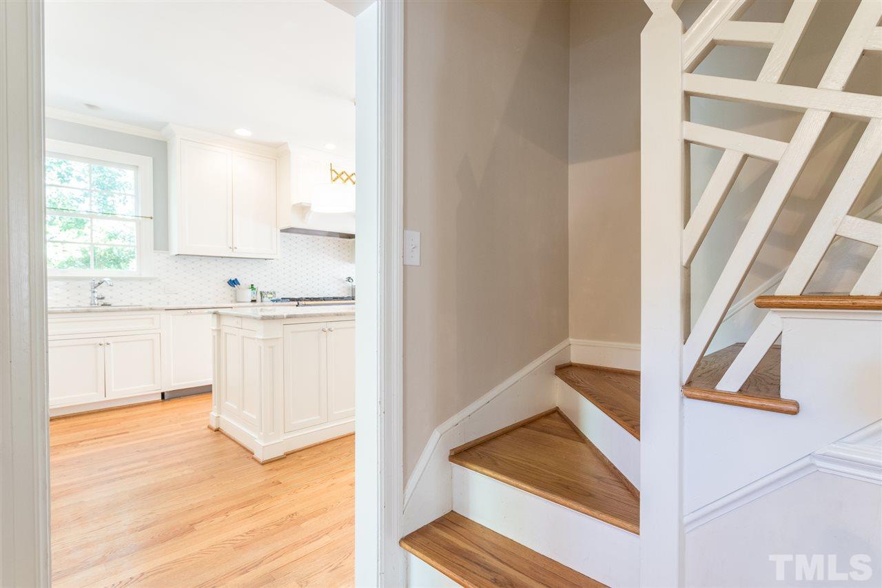 1424 Canterbury Road Raleigh, NC 27608 - Photo 7 of 29 a kitchen with white cabinets and sink