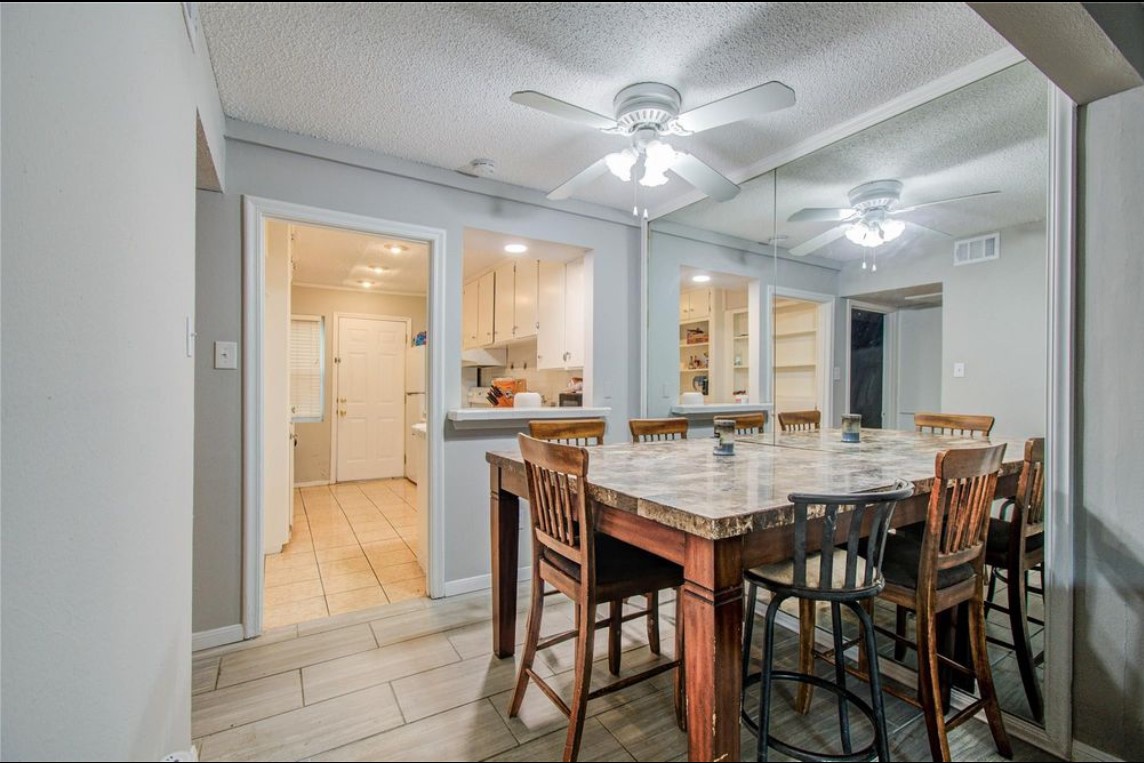 11609 Chimney Rock Road, Unit B Houston, TX 77035 - Photo 13 of 22 a view of a dining room with furniture and a chandelier