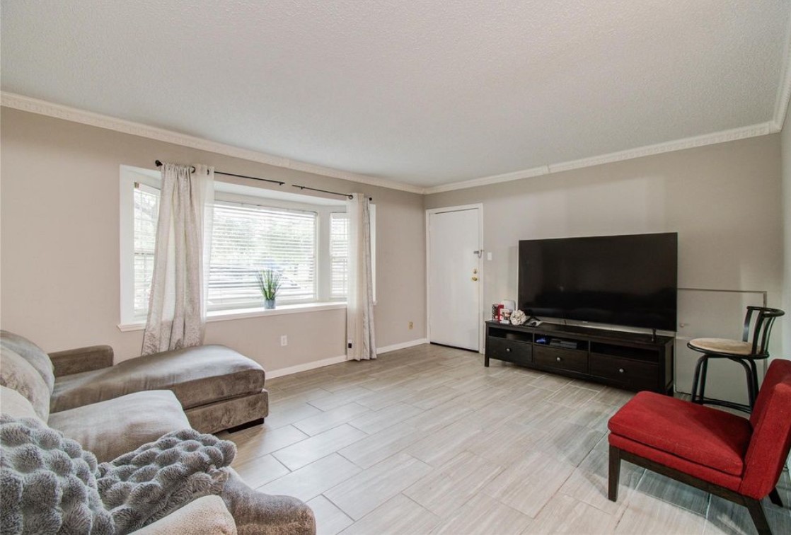 11609 Chimney Rock Road, Unit B Houston, TX 77035 - Photo 14 of 22 a living room with furniture and a flat screen tv