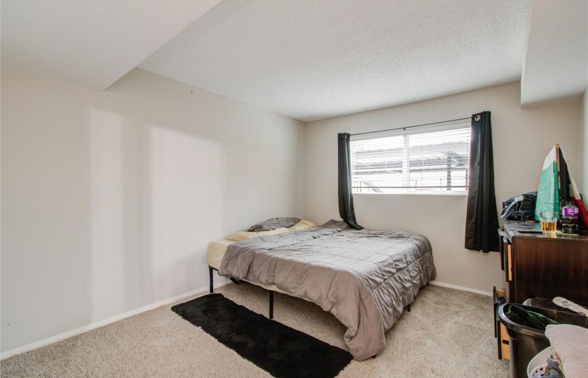 11609 Chimney Rock Road, Unit B Houston, TX 77035 - Photo 16 of 22 a bedroom with a bed and a window