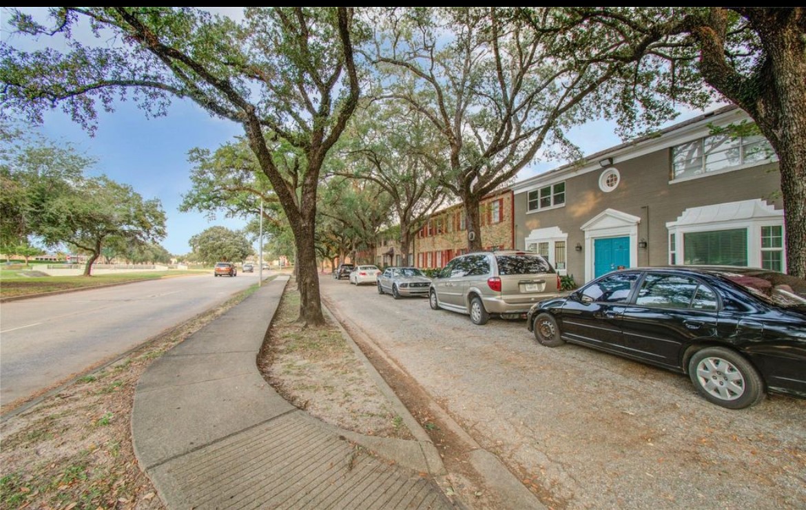 11609 Chimney Rock Road, Unit B Houston, TX 77035 - Photo 5 of 22 a front view of a house with a yard and parking space