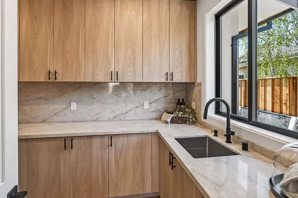 a kitchen with a sink cabinets and window