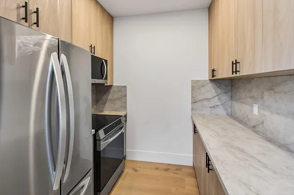 a view of a kitchen counter space and stainless steel appliances