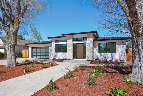 a front view of a house with yard outdoor seating and barbeque oven