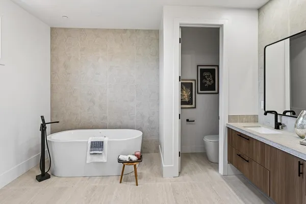 a bathroom with 2 sink tub and a mirror