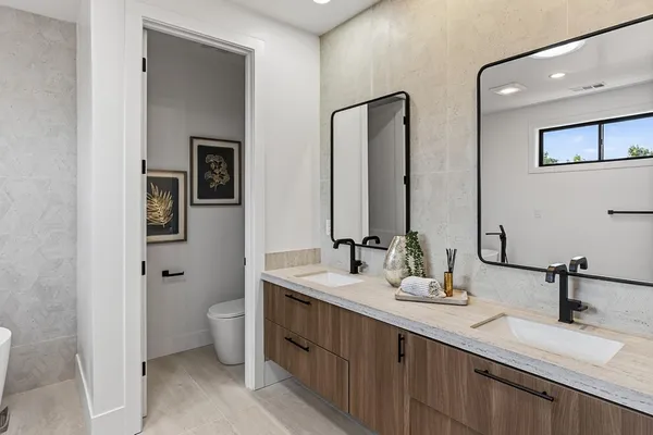 a spacious bedroom with a bed and a cabinets