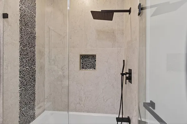 a bathroom with a sink toilet tub and shower