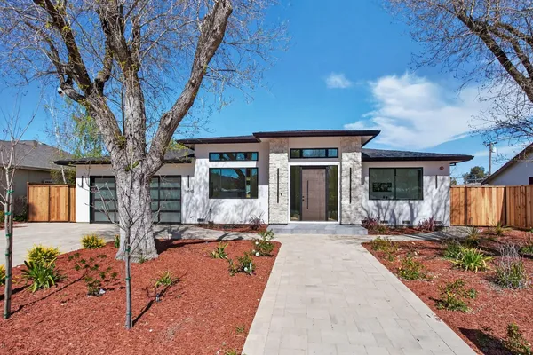 a front view of a house with garden