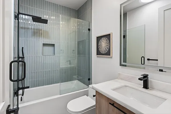 a bathroom with a shower a sink a toilet and shower