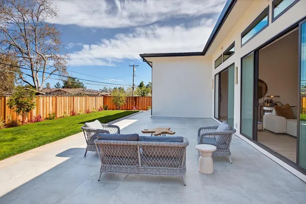 a view of a chair and tables in patio of the house