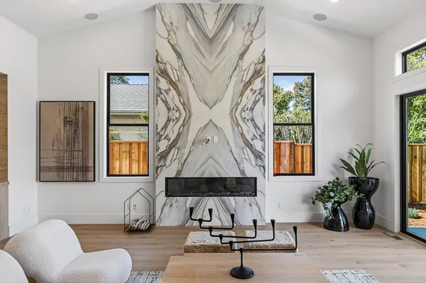 a living room with furniture and potted plants