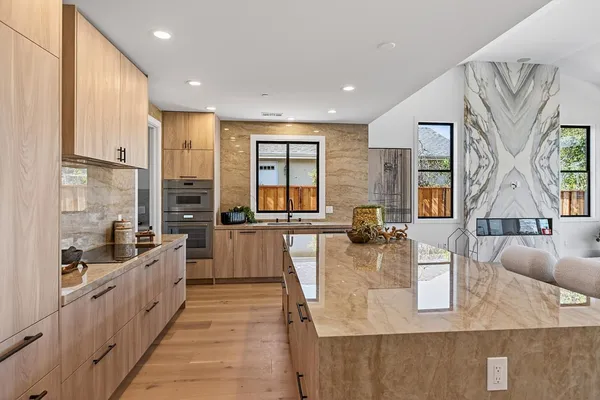 a large kitchen with stainless steel appliances lots of counter top space