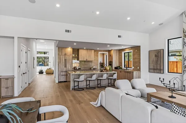 a living room with furniture and wooden floor