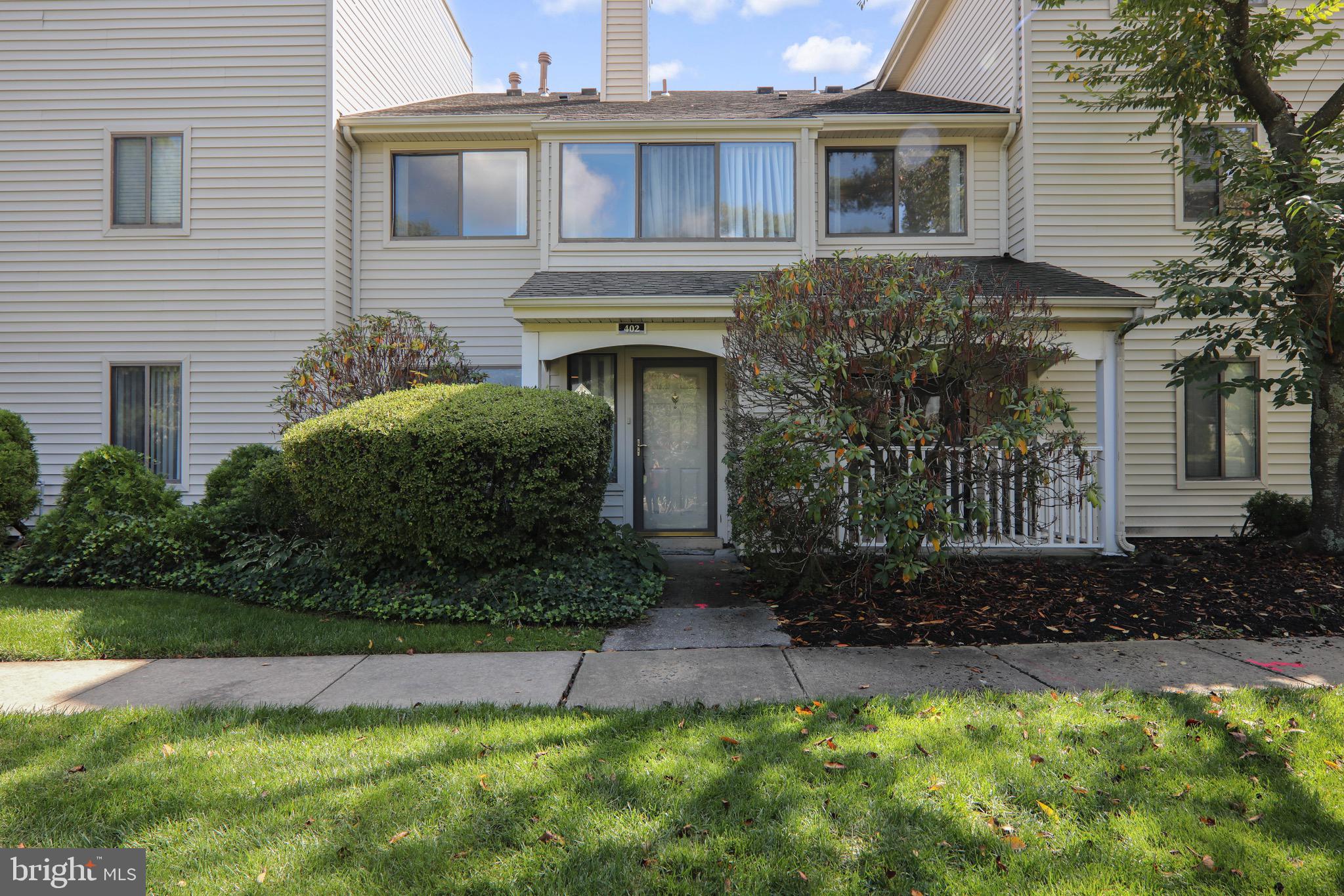 402 Gregorys Way Voorhees, NJ 08043 - Photo 1 of 27 a front view of a house with garden