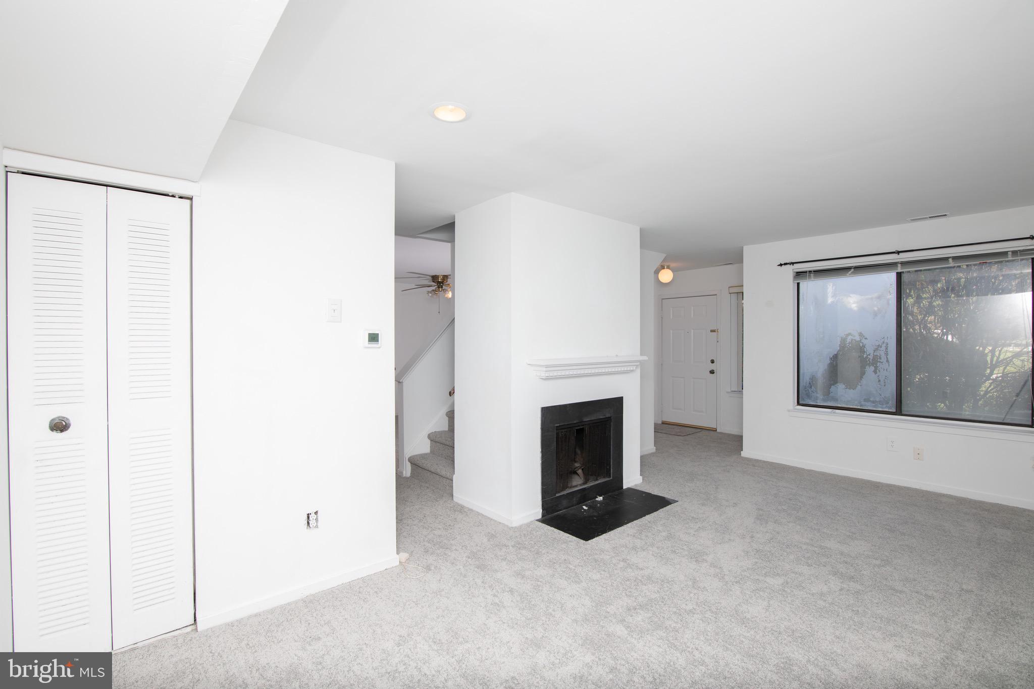 402 Gregorys Way Voorhees, NJ 08043 - Photo 3 of 27 a view of an empty room with a fireplace and a window