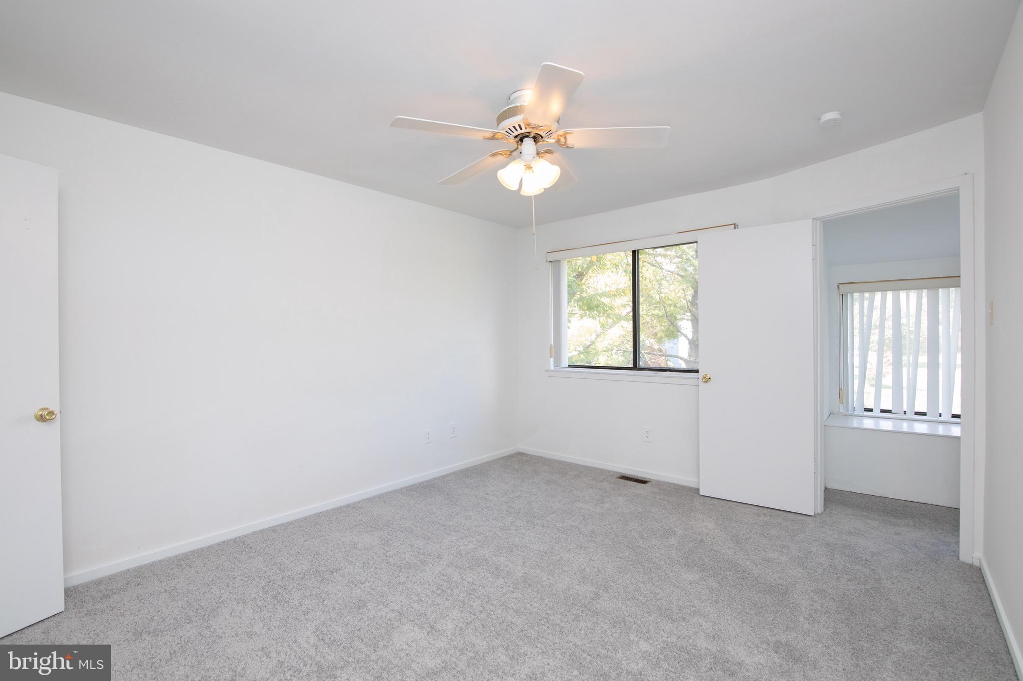 402 Gregorys Way Voorhees, NJ 08043 - Photo 8 of 27 an empty room with windows and chandelier fan