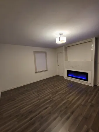 a view of empty room and wooden floor