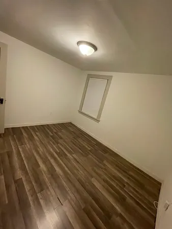 a view of room with wooden floor
