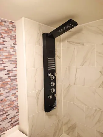 a bathroom with a shower and a curtain