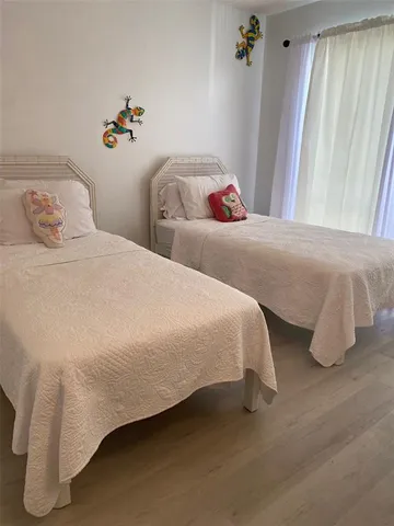 a bedroom with bed and window