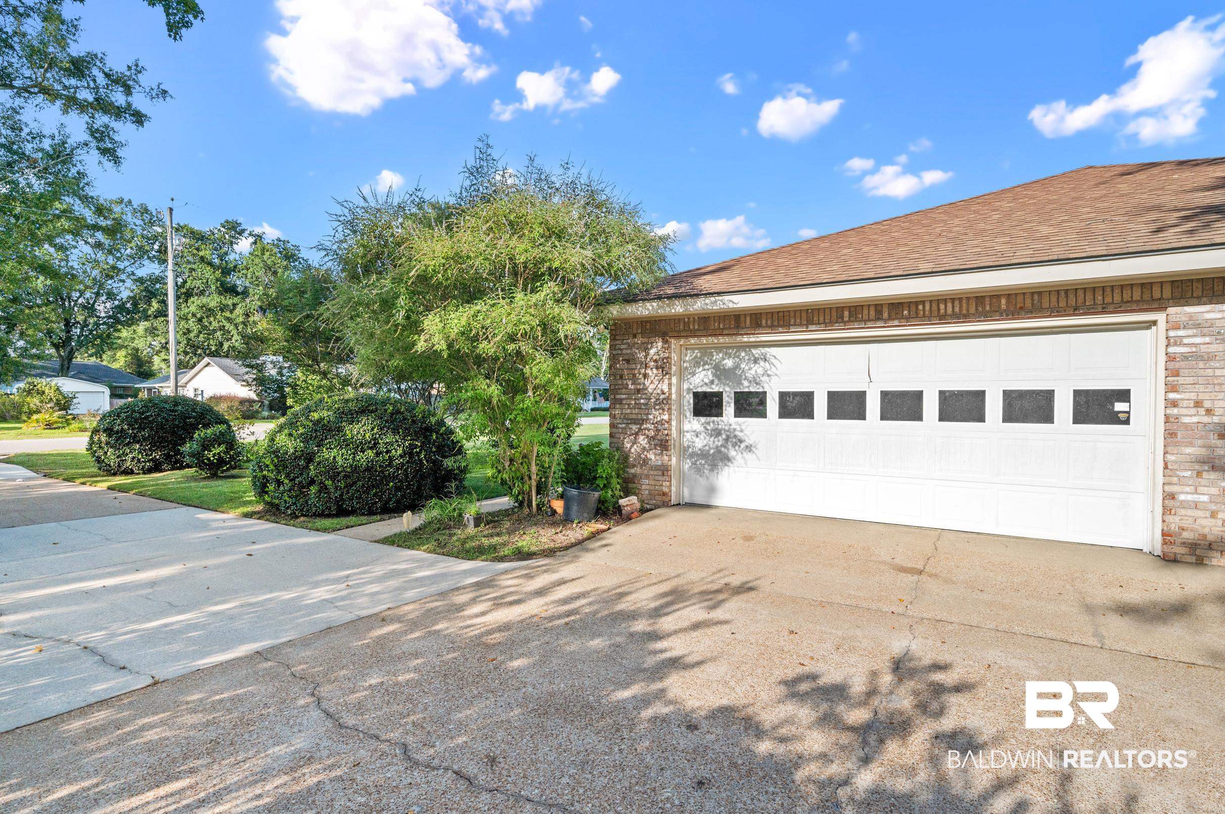 303 West Palm Avenue Foley, AL 36535 - Photo 26 of 32 View of side of home featuring a garage
