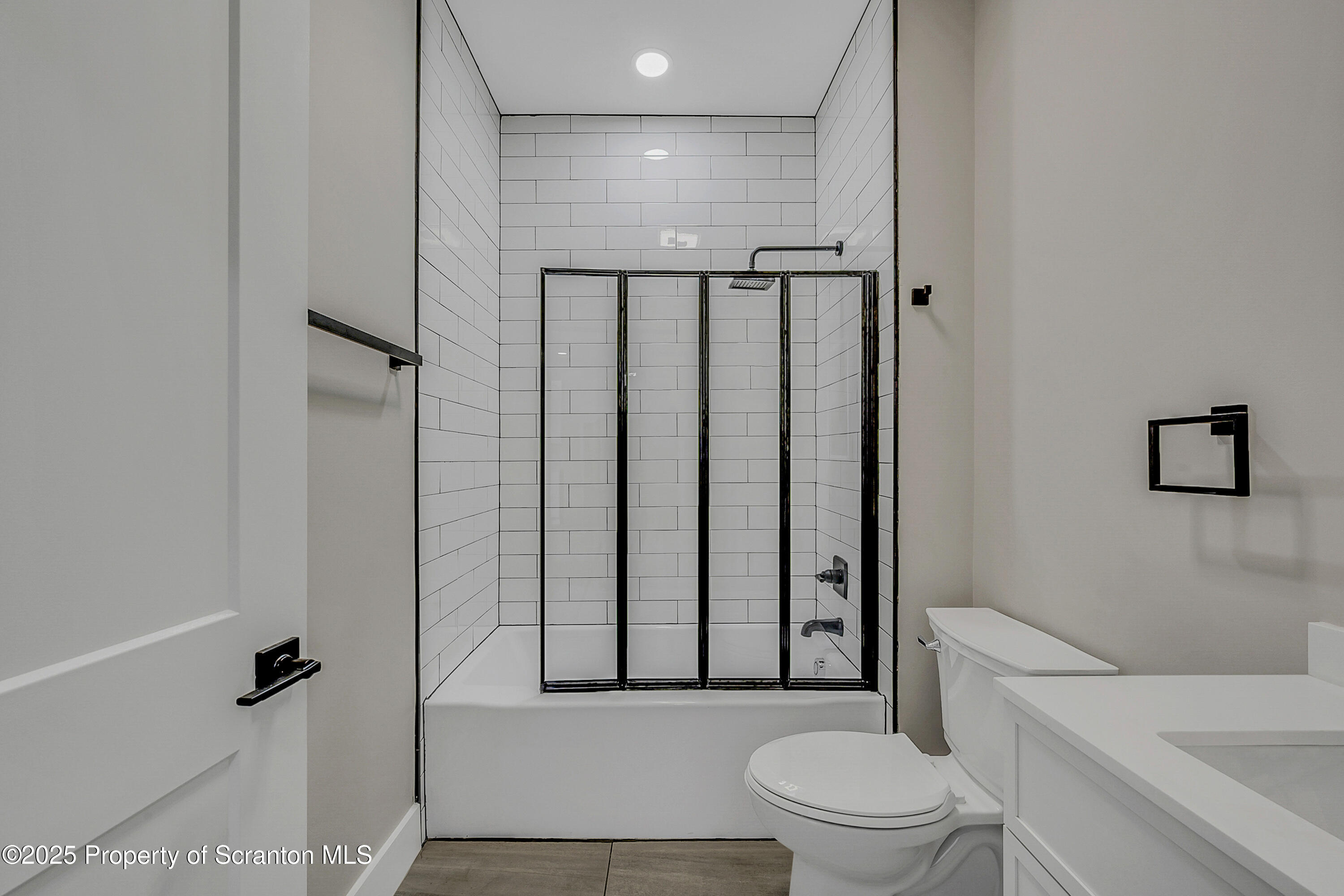 215 Hickory Street, Unit 11 Scranton, PA 18505 - Photo 11 of 13 a bathroom with a toilet a sink and a shower
