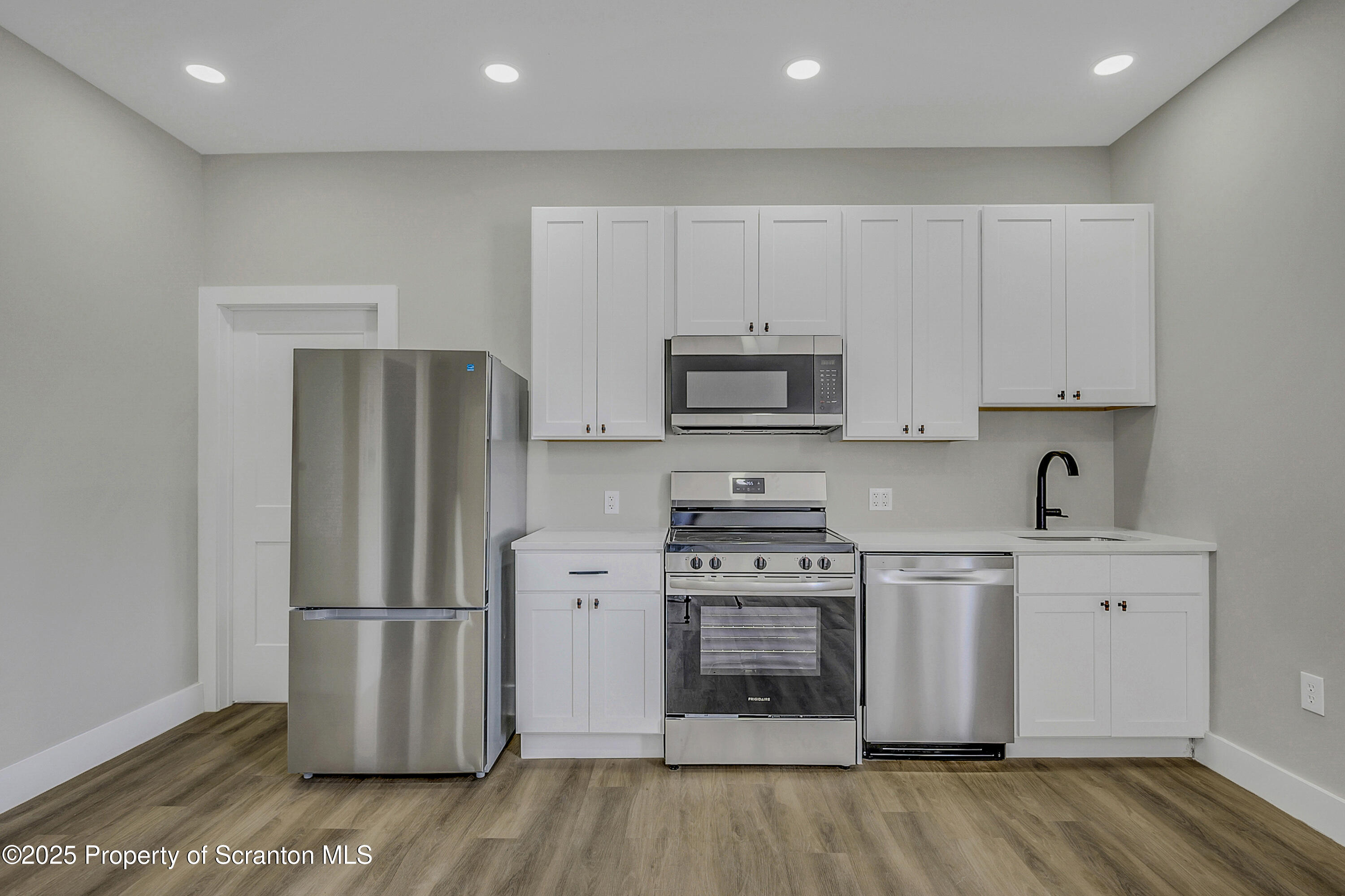 215 Hickory Street, Unit 11 Scranton, PA 18505 - Photo 2 of 13 a kitchen with stainless steel appliances a refrigerator stove and sink