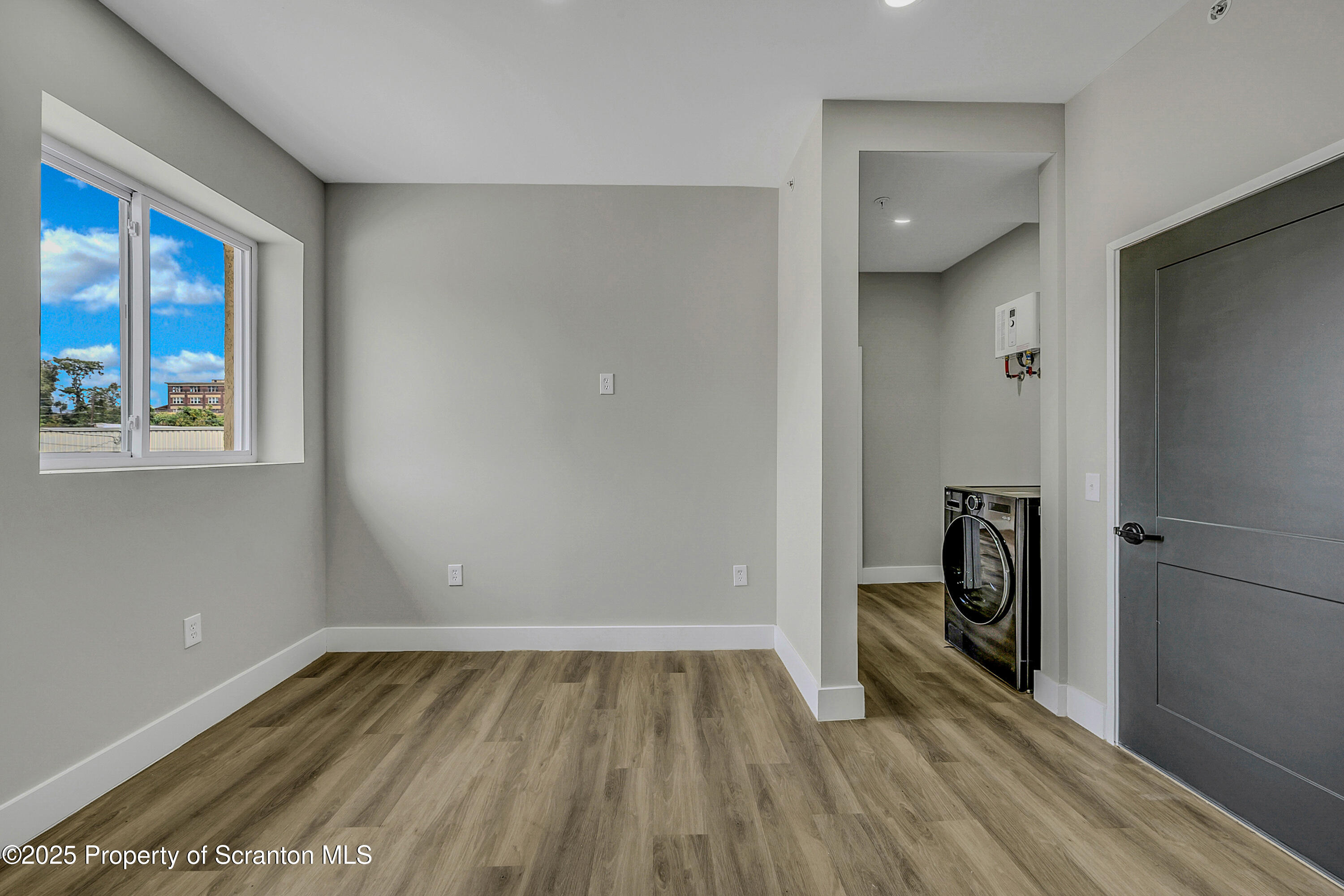 215 Hickory Street, Unit 11 Scranton, PA 18505 - Photo 5 of 13 a view of empty room with wooden floor and fan