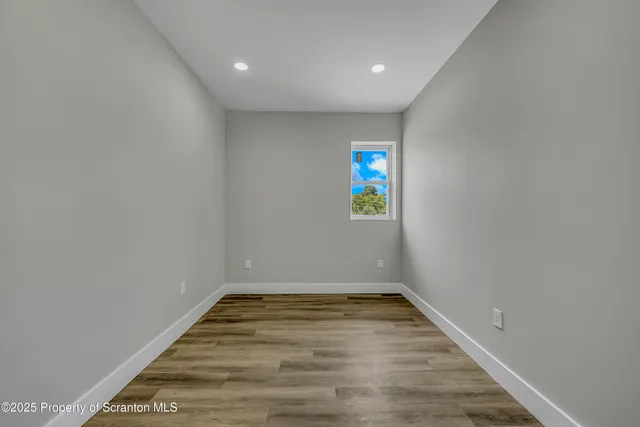 a view of a room with wooden floor