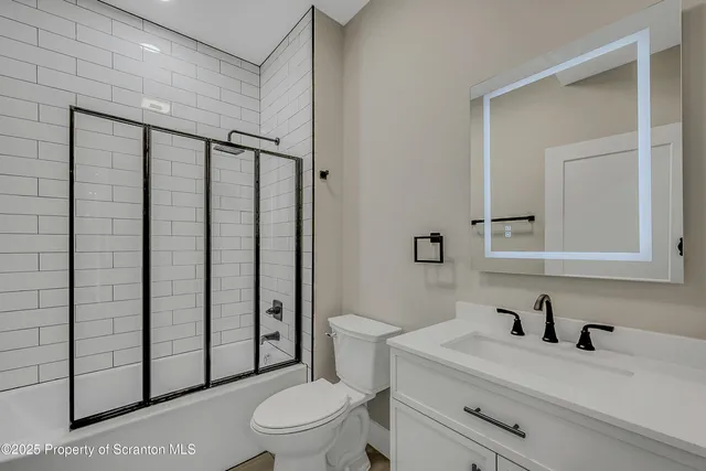 a bathroom with a toilet a sink and a shower