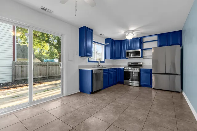 a kitchen with stainless steel appliances granite countertop a refrigerator sink and cabinets
