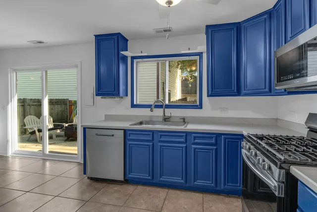 a kitchen with stainless steel appliances granite countertop wooden cabinets a sink and a stove