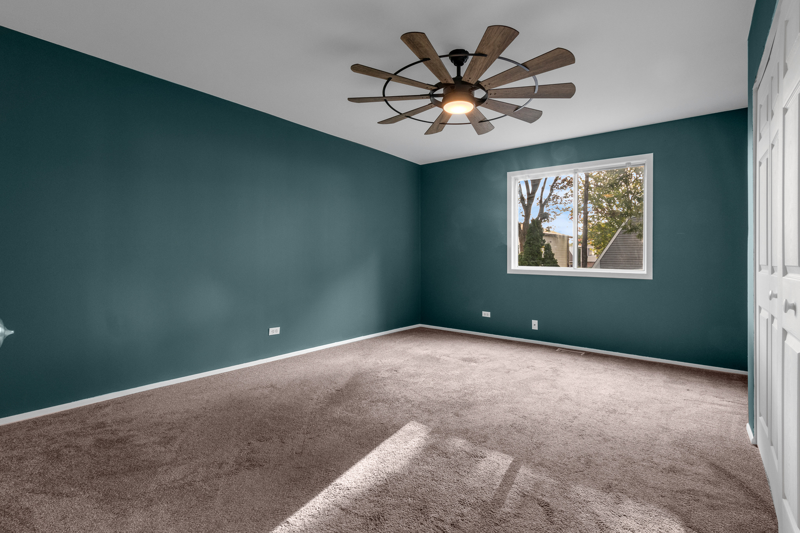 614 Kamiah Court Carol Stream, IL 60188 - Photo 21 of 30 an empty room with a chandelier fan and windows