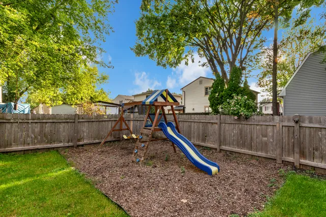 a view of a backyard with swings