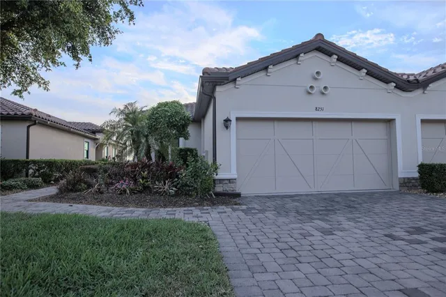 a front view of house with yard and trees