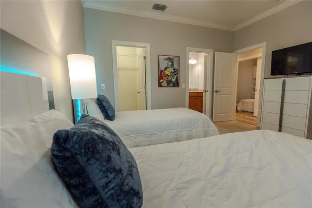 a bedroom with a bed and a mirror in it