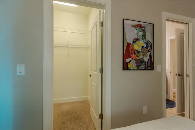a view of a hallway with painting on the wall