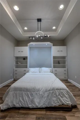 a bedroom with a bed and a chandelier