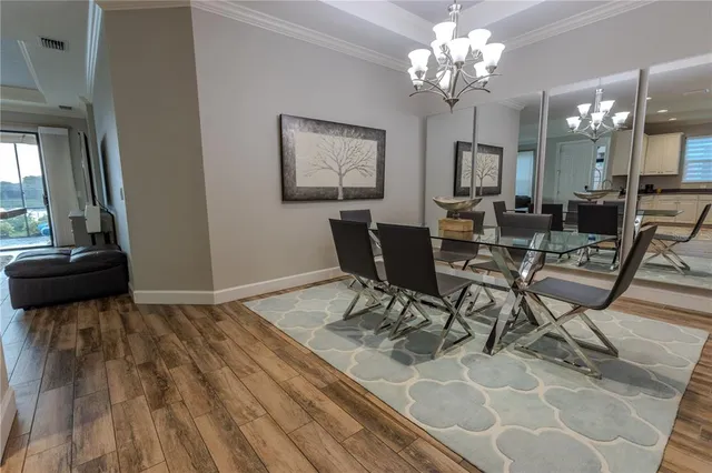 a view of a dining room with furniture and a chandelier