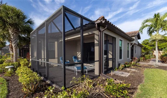 a view of a house with yard and sitting area