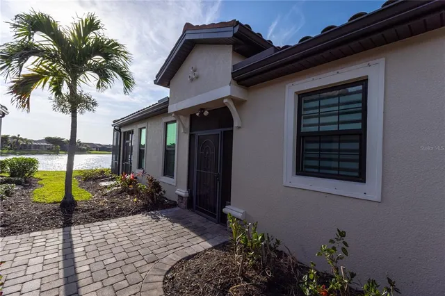 a couple of potted plants in front of house