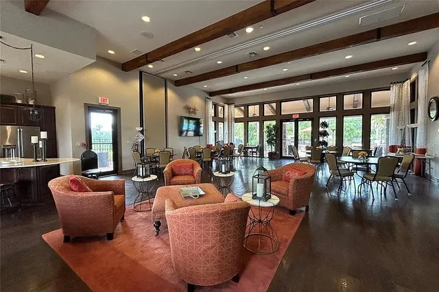 a living room with fireplace furniture and a large window