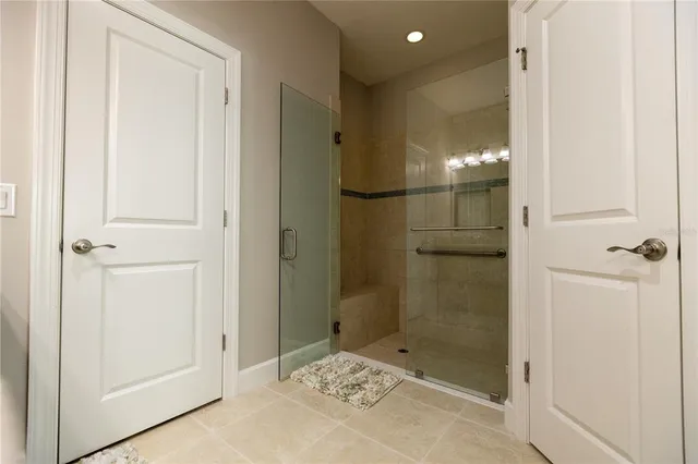 a bathroom with a glass shower door
