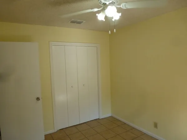 a view of a hallway with a chandelier fan