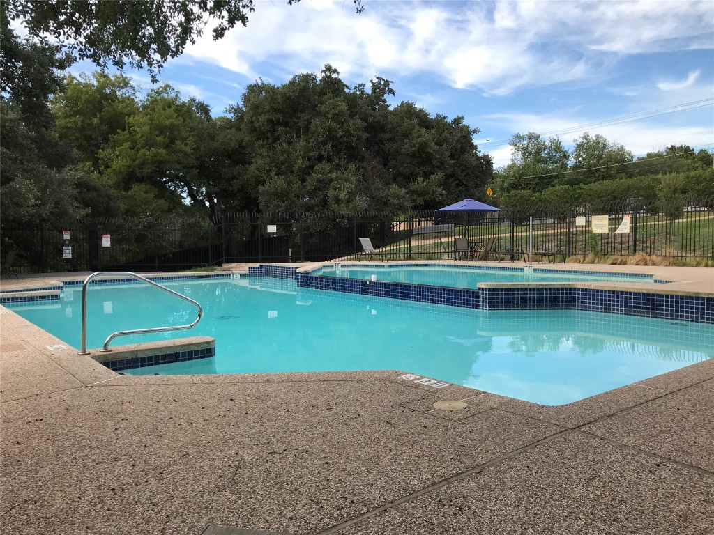 1015 East Yager Lane, Unit 87 Austin, TX 78753 - Photo 21 of 22 a view of a swimming pool with a yard and sitting area