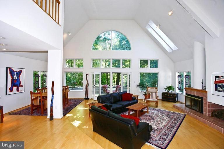 11584 Greenwich Point Road Reston, VA 20194 - Photo 1 of 23 a living room with furniture large window and a fireplace
