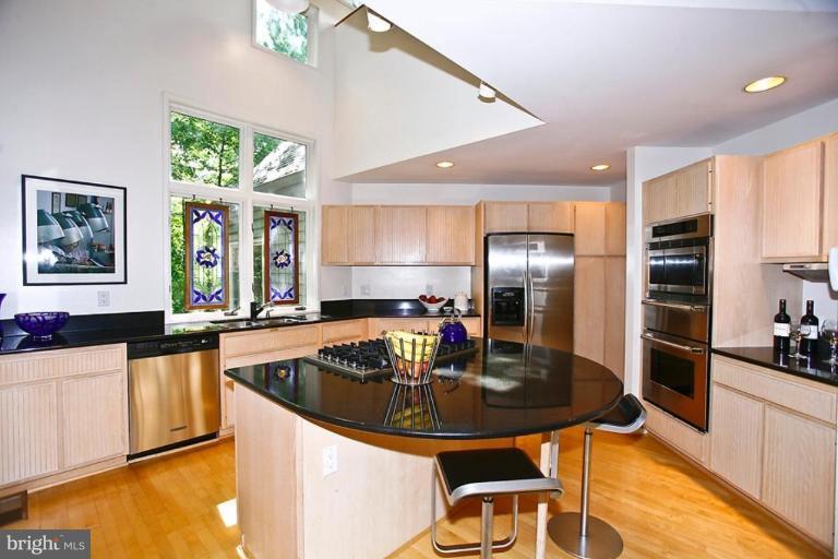 11584 Greenwich Point Road Reston, VA 20194 - Photo 22 of 23 a kitchen with a sink a counter top space and stainless steel appliances
