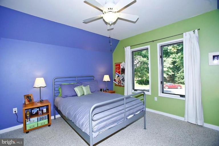 11584 Greenwich Point Road Reston, VA 20194 - Photo 8 of 23 a bedroom with a bed and a chandelier