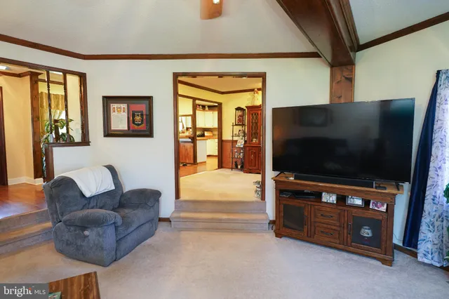 a dining room with wooden floor a chandelier a glass table and chairs